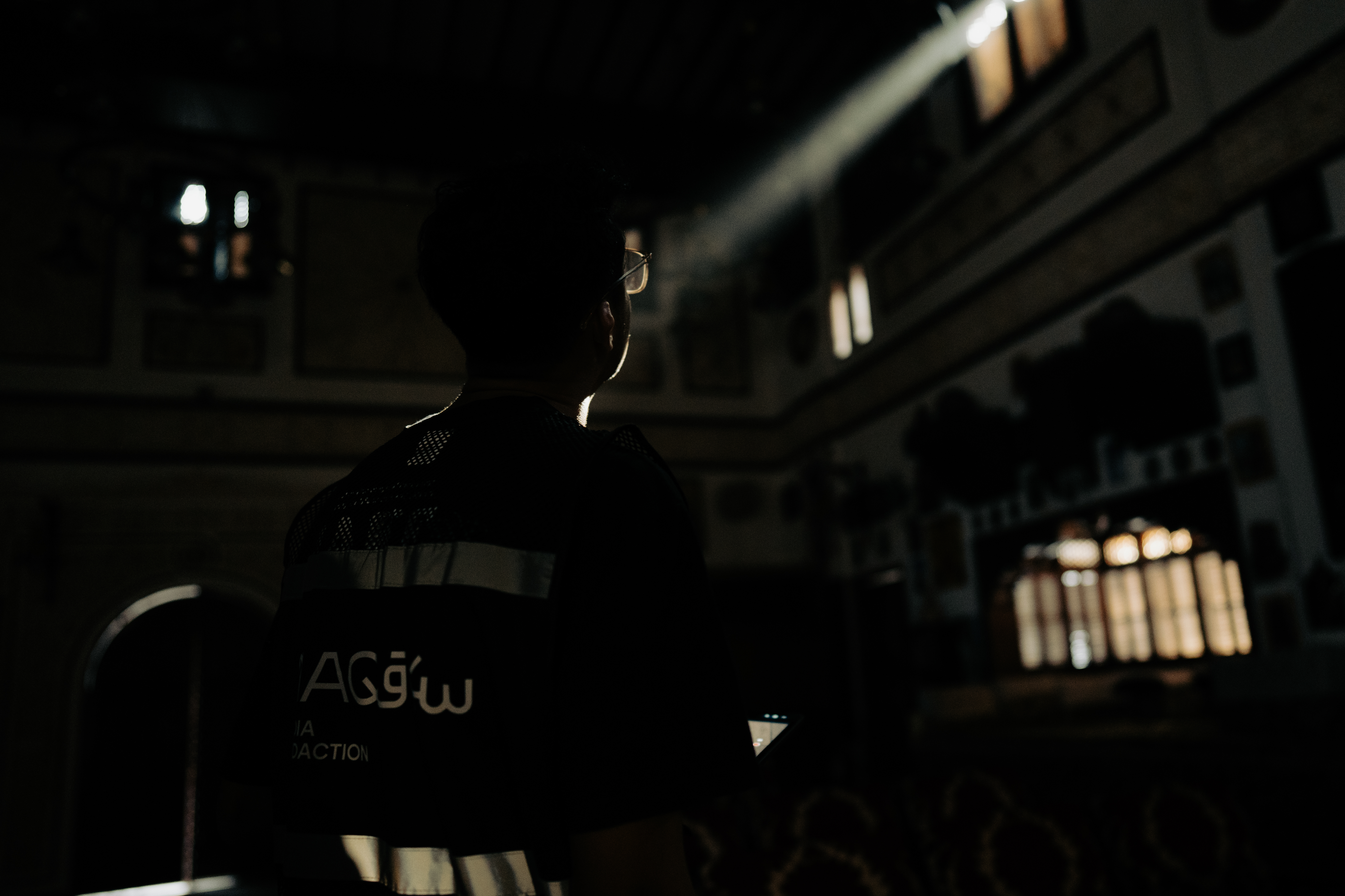 Silhouette of a filmmaker beside a light